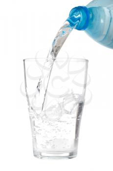 Royalty Free Photo of a Bottle of Water Being Poured into a Glass
