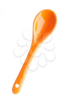 Royalty Free Photo of an Orange Porcelain Spoon