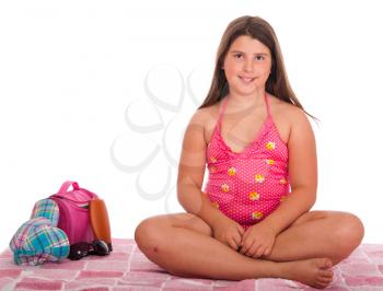 Royalty Free Photo of a Girl Sitting in a Bathing Suit