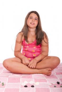 Royalty Free Photo of a Girl Sitting in a Bathing Suit