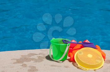Royalty Free Photo of Toys by the Poolside