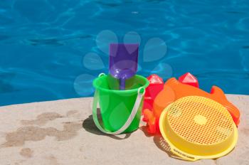 Royalty Free Photo of Toys by the Poolside