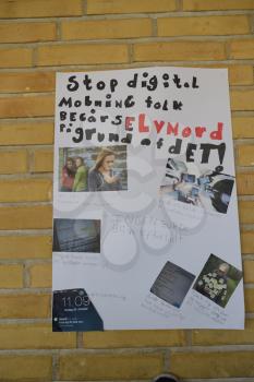 Stop bullying poster made by students hanging on wall