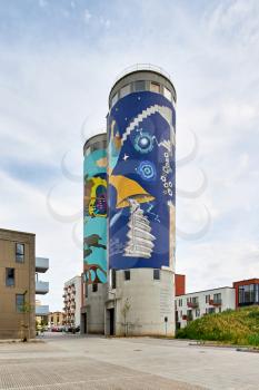cylinder building with a mural painted on it