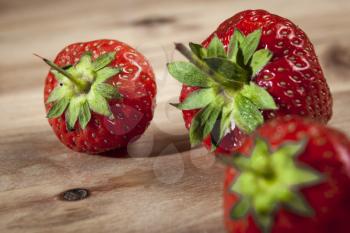 Closeup of red and fresh strawberries on wooden table