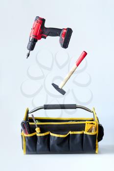 handy man tools in a large bag with white background