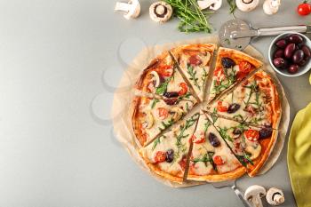 Delicious pizza and ingredients on table�
