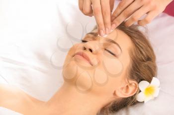 Woman having hair removal procedure on face with wax in salon�