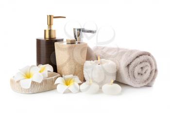 Spa composition with candles, toiletries and clean towel on white background�