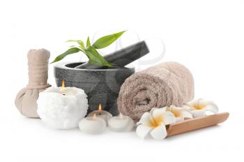 Spa composition with mortar, candles and clean towel on white background�