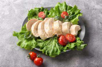 Boiled chicken fillet with lettuce and tomatoes on plate�