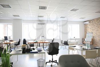 Office interior with tables and armchairs. Workplace design�