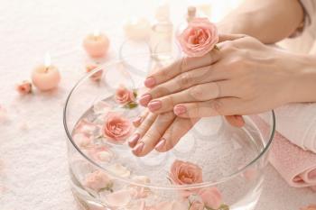 Young woman undergoing spa manicure treatment in beauty salon, closeup�