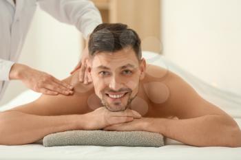 Man having massage in spa salon�