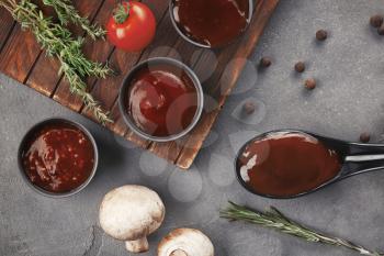 Delicious barbecue sauces in bowls on table�