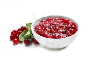Bowl with tasty cranberry sauce on white background�