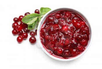 Bowl with tasty cranberry sauce on white background, top view�