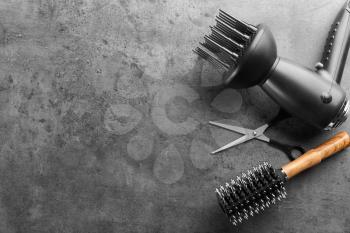 Flat lay composition with set of hairdresser's tools on grey background�