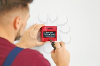 Electrician installing fire alarm system�