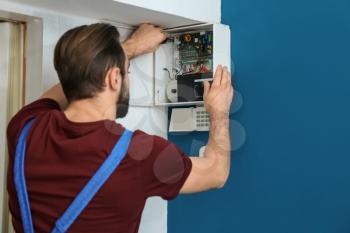 Electrician installing alarm system�