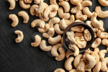 Tasty scattered cashew nuts on slate plate�