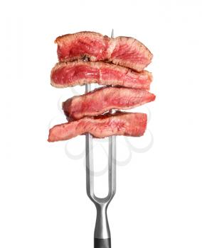 Meat fork with pieces of different steaks on white background�