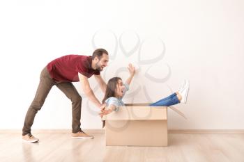 Young couple playing with box indoors. Moving into new house�