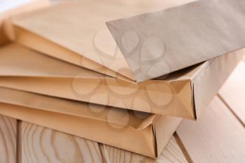 Brown envelopes on wooden table, closeup. Mail service�