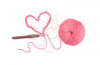 Ball of knitting yarn with crochet hook on white background�