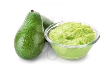 Bowl with tasty guacamole and ripe avocados on white background�