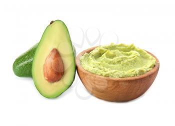 Bowl with tasty guacamole and ripe avocados on white background�