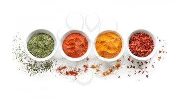 Bowls with various spices on white background�