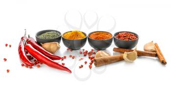 Bowls with various spices on white background�