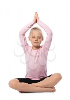 Little girl practicing yoga on white background�