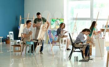 Group of people during classes in school of painters�
