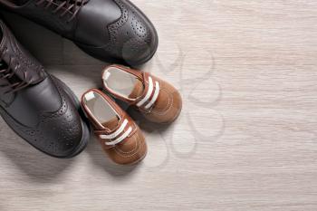 Big and small shoes on light background. Father's day�