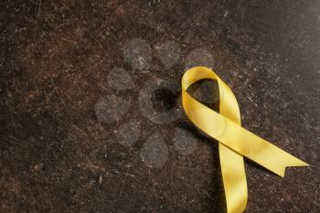 Yellow ribbon on dark background. Cancer concept�