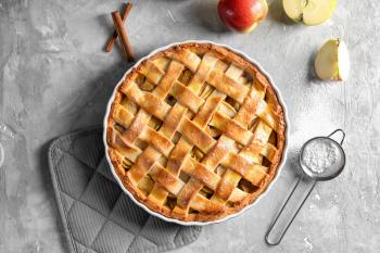Composition with delicious apple pie on light background�