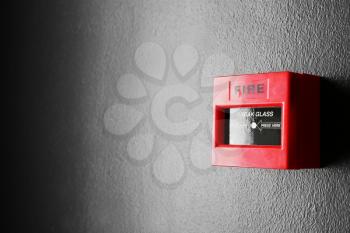Modern fire call point on wall indoors�