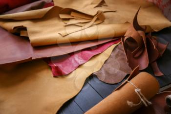 Assortment of colorful leather pieces on table�