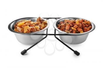 Bowls with pet food on white background�