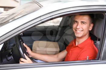 Pizza delivery man driving a car�