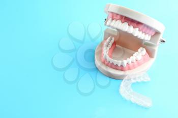 Artificial jaw and occlusal splint on color background�