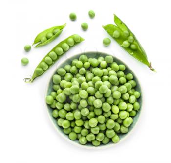 Bowl with green peas on white background�