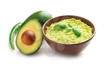 Bowl with tasty guacamole, chili pepper and ripe avocados on white background�