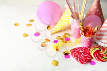 Birthday party items with candies on light background�