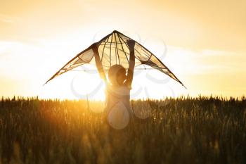 Cute little girl with kite in field�