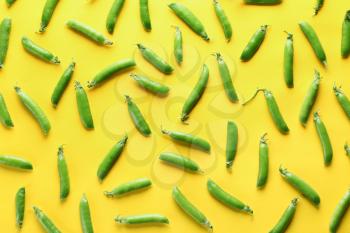 Pods of fresh green pea on color background�