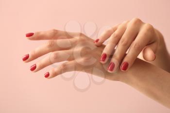 Female hands with beautiful manicure on color background�
