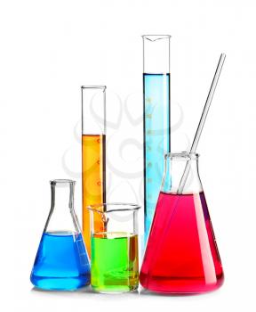 Laboratory glassware with colorful liquids on white background�